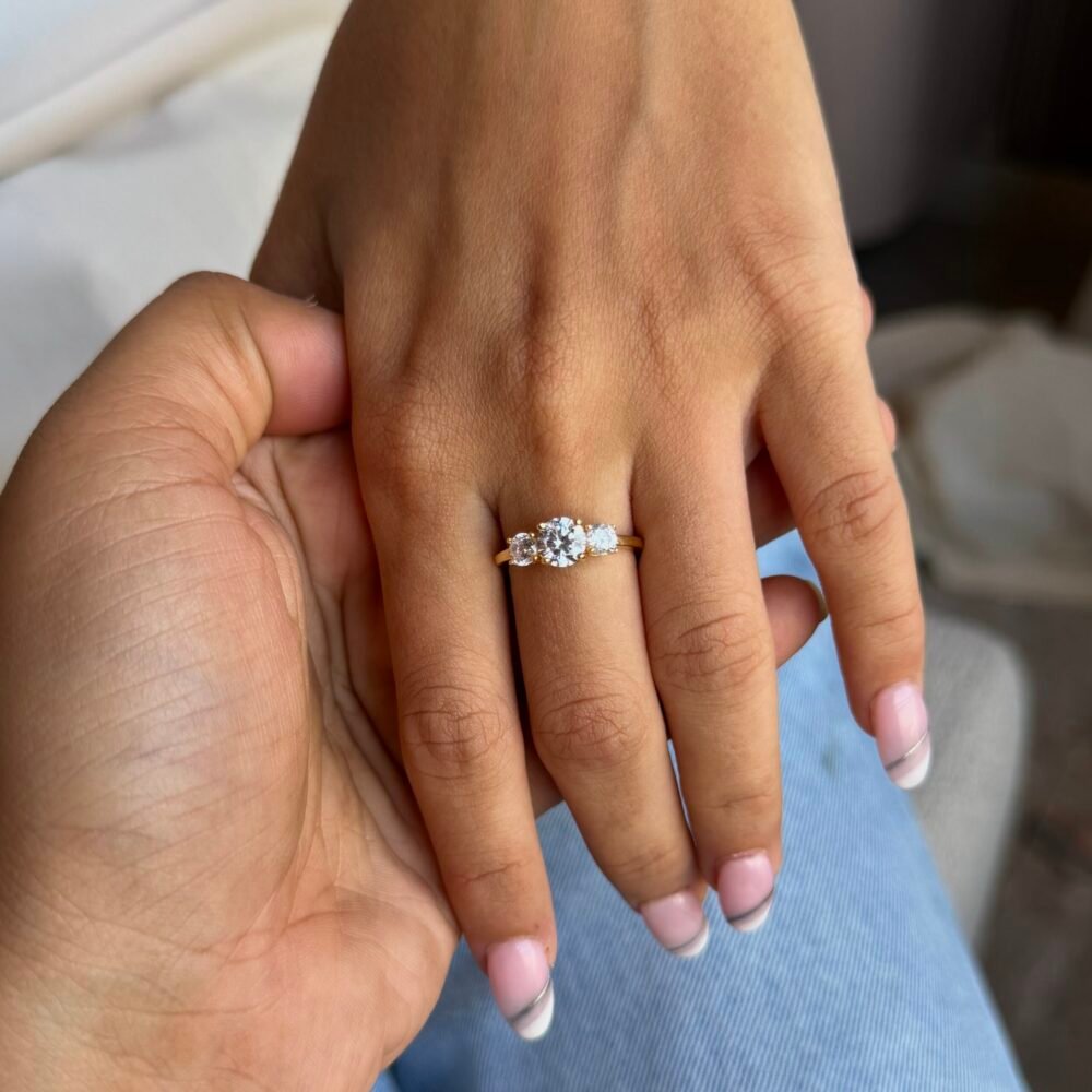 Silver ring with a delicate floral cluster of sparkling stones on a sleek polished band.