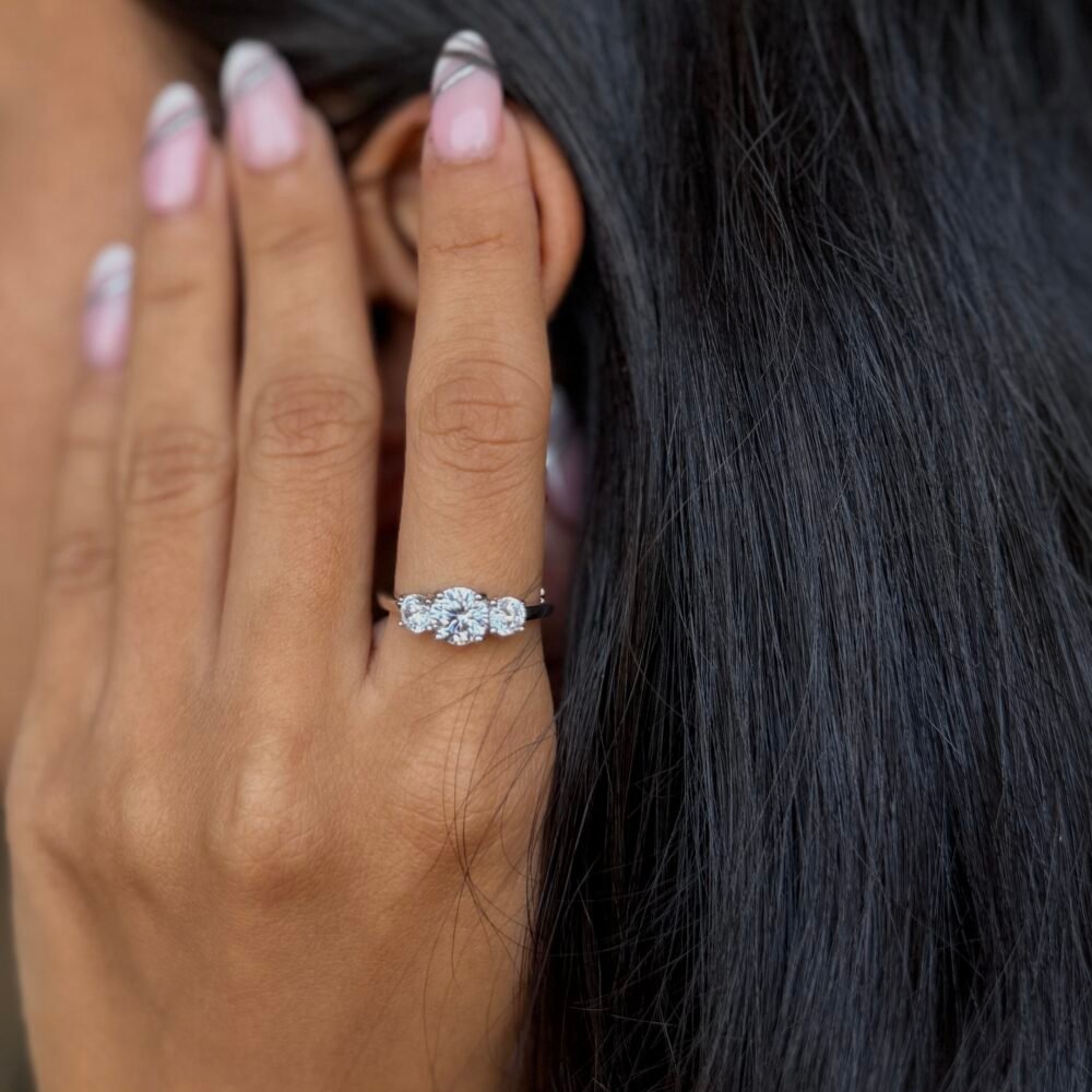 Silver ring with a delicate floral cluster of sparkling stones on a sleek polished band.