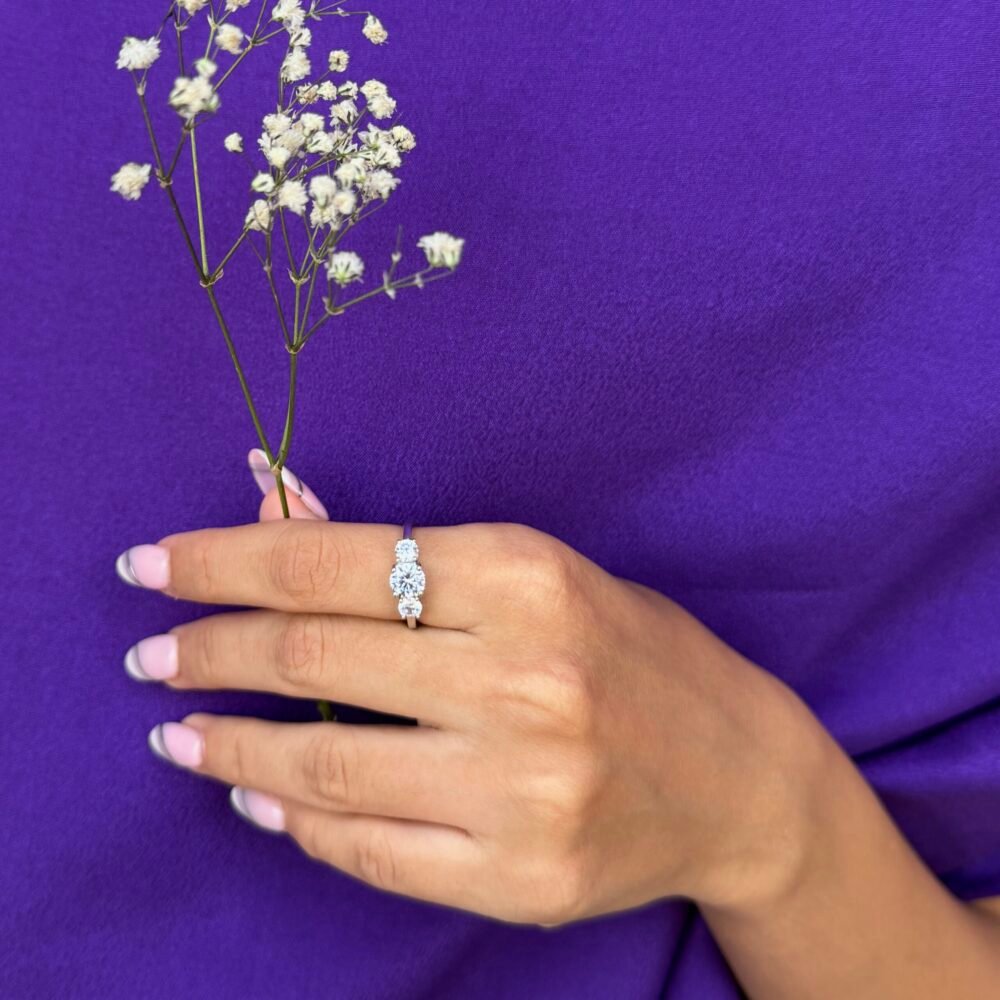Silver ring with a delicate floral cluster of sparkling stones on a sleek polished band.